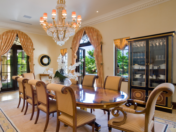 The main dining room is adorned with a crystal chandelier and has a table that seats 12 guests.