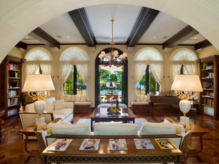 The living room features exposed wooden beams ...