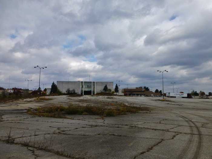 The outside of the mall decayed along with the inside. Weeds sprouted up between cracks in the parking lot.