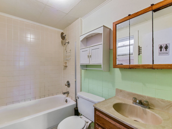 A small bathroom is just outside the bedroom off of the kitchen.