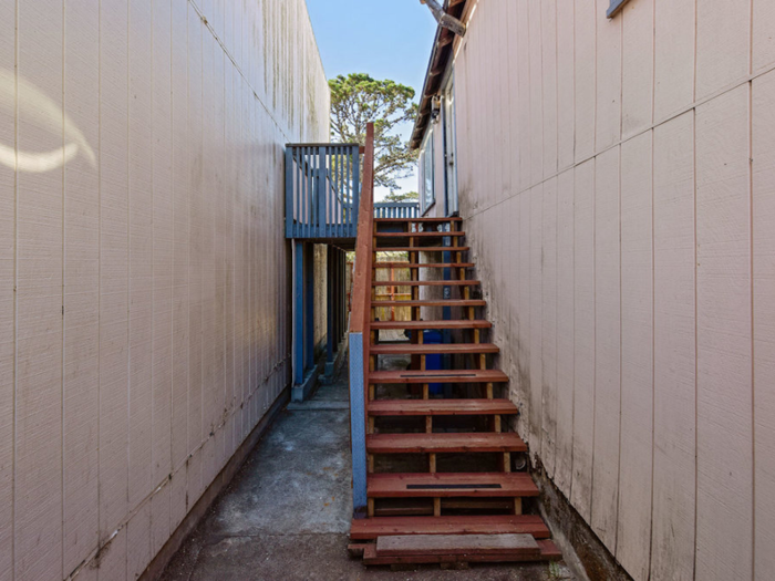 A staircase leads up to the front door.