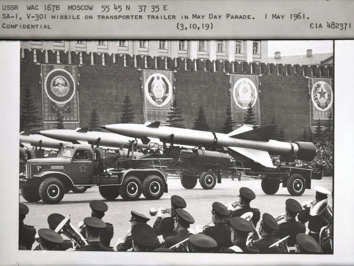 Ground-launched surface-to-air missiles pass by as the band plays during the 1961 May Day parade.