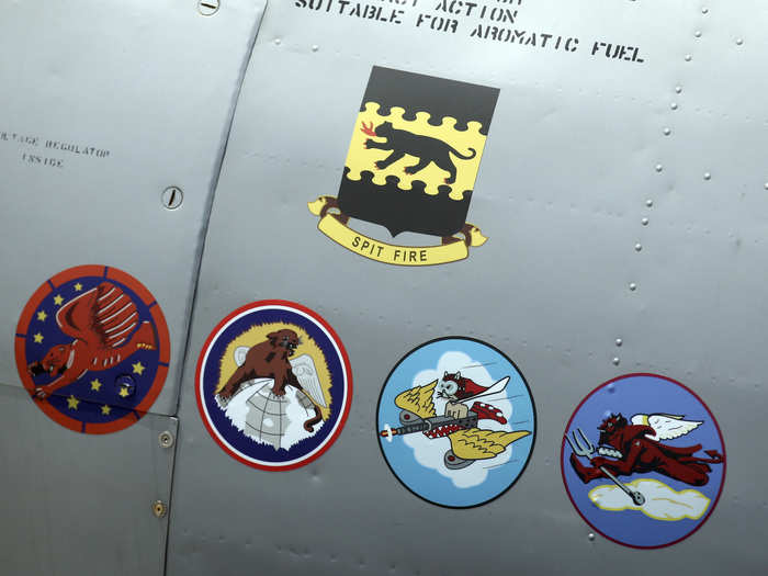 Here are insignia for various squadrons on an AY-6 Texan aircraft during a 2012 ceremony honoring Tuskegee Airmen. The top emblem is for the 332nd Fighter Group. The unit insignia, from left to right, are for the 99th, 100th, 301st and 302nd Fighter Squadrons.