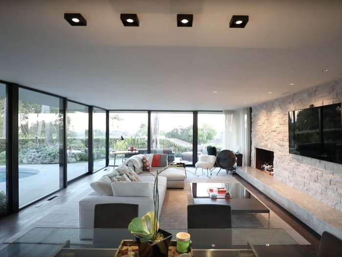 Once inside, huge floor-to-ceiling windows let in natural light to the open living space.