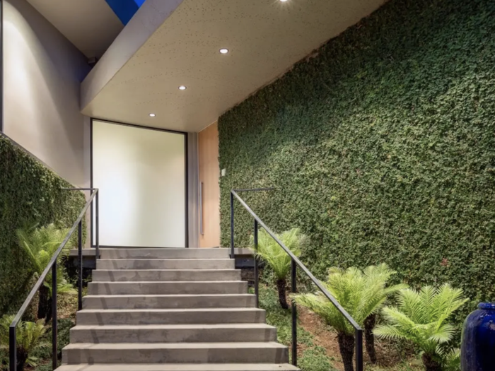 Large privacy hedges help the home stay secluded despite how close it is to the street.