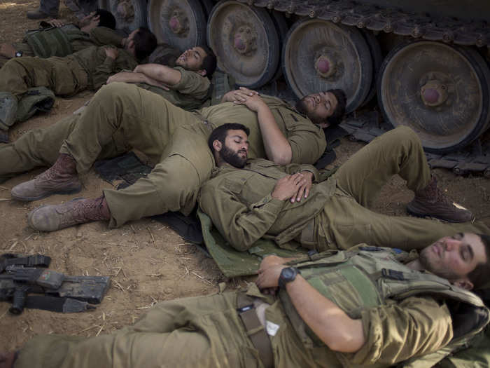 8. In the shade provided by vehicles, sometimes using each other as pillows.