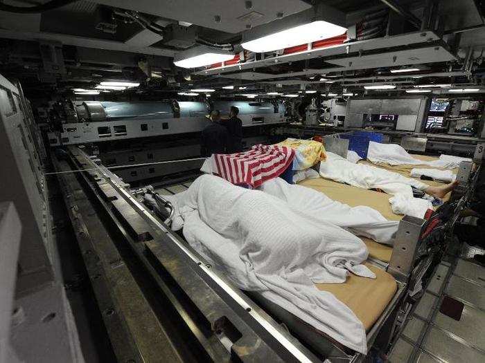 Sailors draped towels over themselves to shield them from the lights.