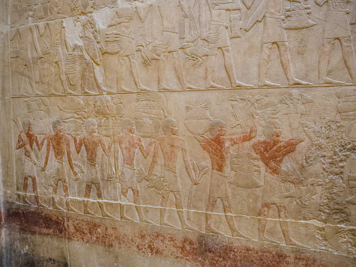 The walls are lined with bas relief carvings depicting scenes of daily life in ancient Egypt.