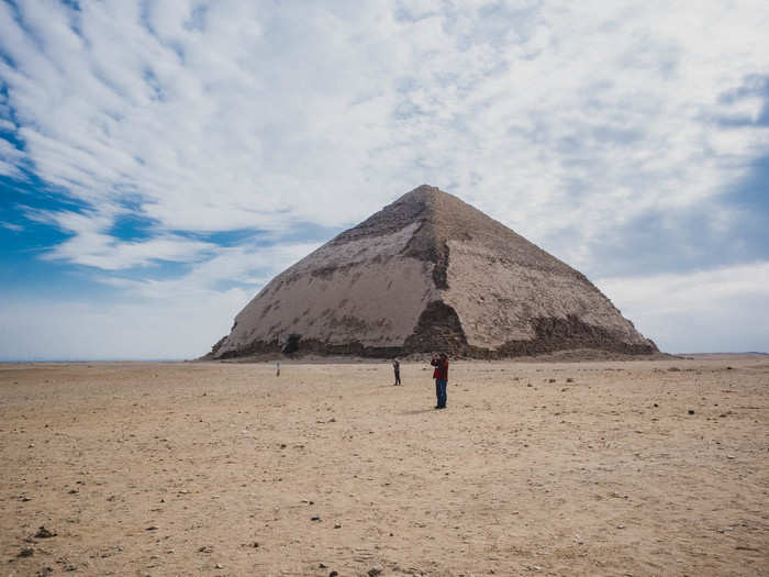 Nearby in Dahshur is the Bent Pyramid. Also built under orders by Sneferu, the Bent Pyramid was the first attempt at building a smooth-sided pyramid, many Egyptologists believe. The pyramid collapsed due to the use of gravel and clay at the base and the shape of the blocks.