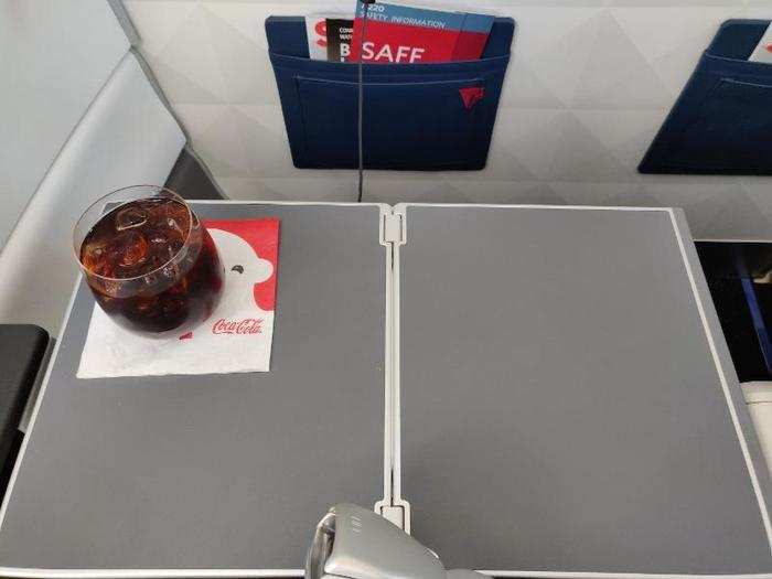 My seat was equipped with an armrest-mounted collapsible tray table. You can unfurl it for meals or...