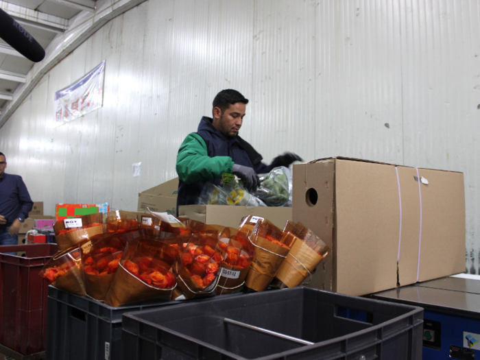 The rolled-up flowers are placed into a box. Much of the processing facility was warm, but the boxing area is especially chilly.