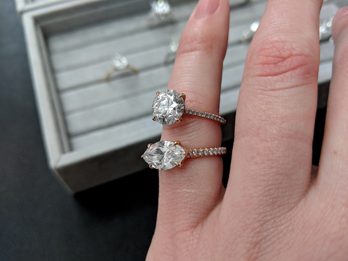 Beyond the diamond itself, clients have to consider the setting, which includes the band, prongs, and any additional rows of diamonds, as can be seen on these two rings. Each setting is custom-made for the diamond the client picks.