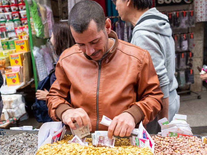 For now, we had to stick to buying snacks. This seller offered up bags of fresh nuts and seeds for less than a dollar a pop. He had a great sense of humor, posing for a few photos.