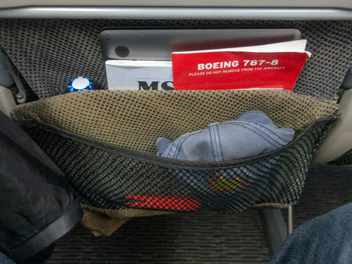 There are two pockets on the seat-back for your stuff. I love this idea. The outer one is mesh so you can see what you put in there at any time. For a very forgetful person like me, it