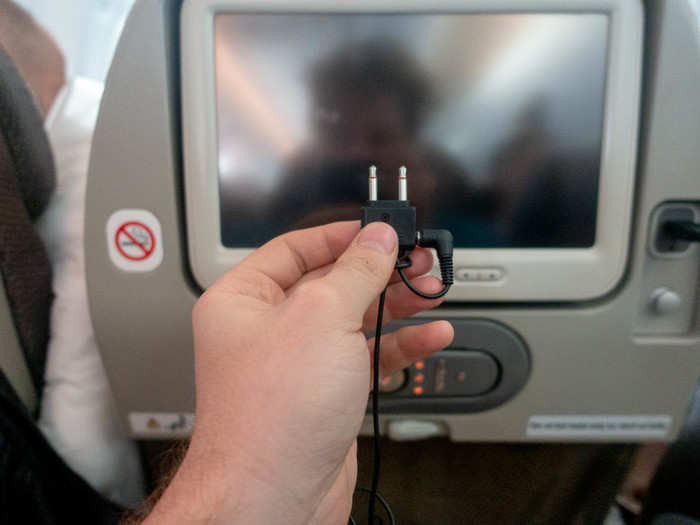 Why do airlines continue to use the two-pronged connector for the headphones? Many people carry expensive noise-cancelling headphones these days and would probably like to use them with the entertainment system.