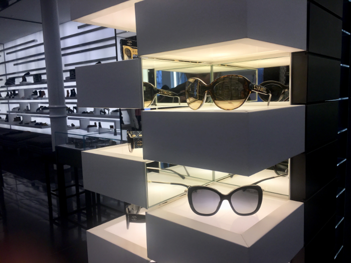 Overall, the store was dominated by simple lines and a monochromatic color scheme. Lights illuminated both sunglass displays ...