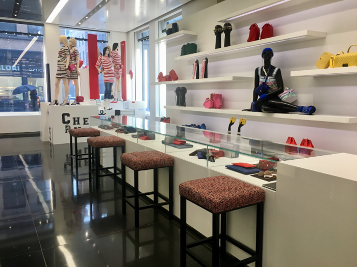 On the opposite side of the store, a counter featured a line of stools where customers can sit while employees assist them with their purchase.