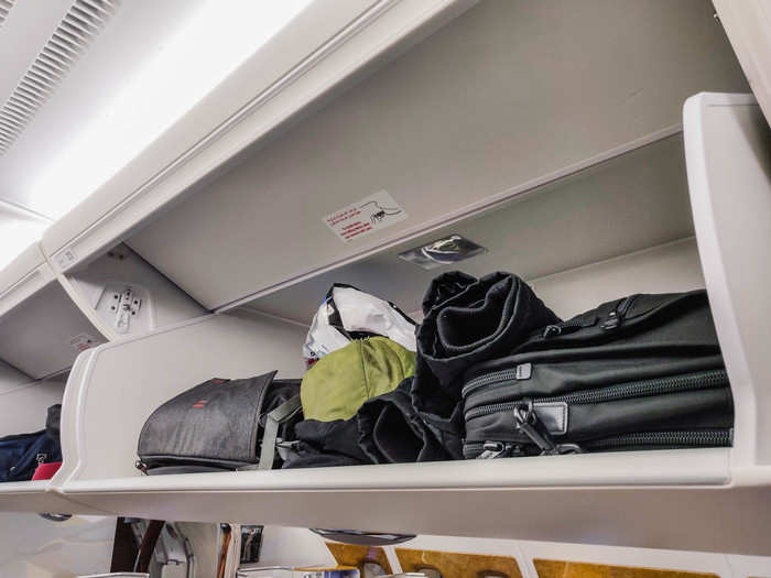 Each seat has its own overhead compartment. I was able to put both my backpacks, my sweater, and my souvenirs bag up there without having to fight with other passengers for space.