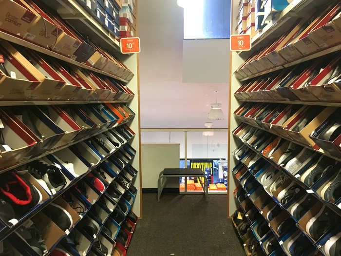 The shoe boxes sat straightened on the shelves ...