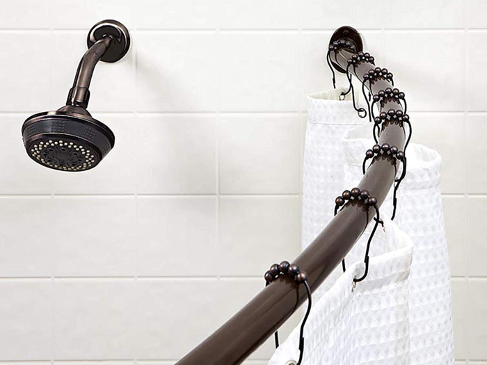 An adjustable, curved shower curtain rod