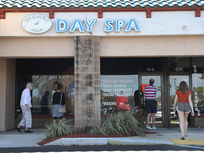 After news broke of the scandal on Friday, people were seen milling around in front of the spa.