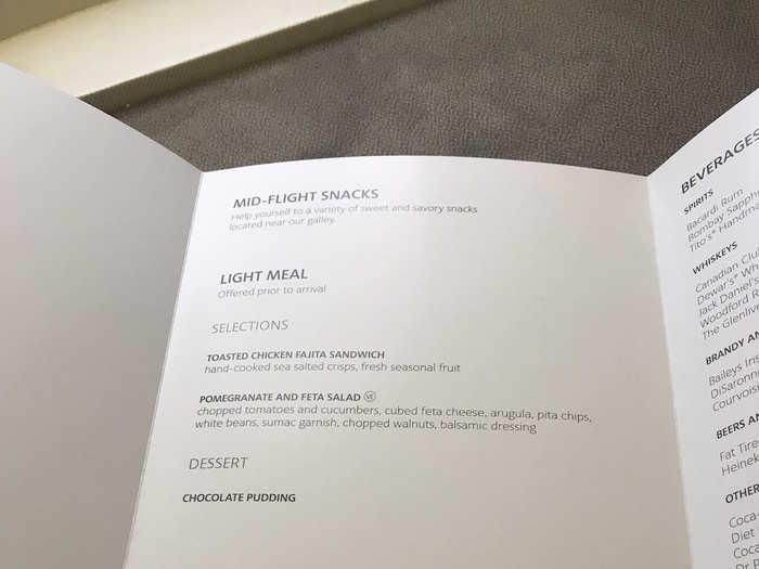 After the meal was cleared away, a selection of snacks — like chocolate bars, chips, fruit, and sandwiches — were put out in the galley that business class passengers were welcome to choose from for a few hours. There were also plenty of mini water bottles on hand.