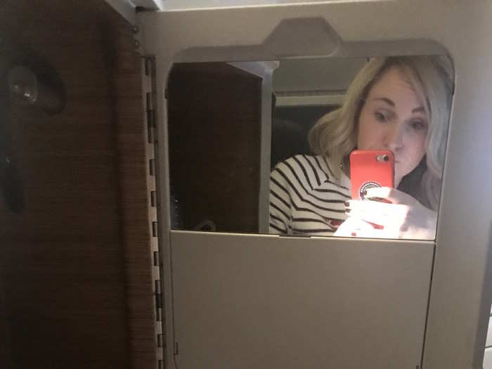 I was at least an hour into the flight before I realised there was another compartment to my left. Inside there was a mirror, a little popup shelf (helpful for makeup application), a water bottle, an amenity kit, and the plug for the Bose headphones (I hadn