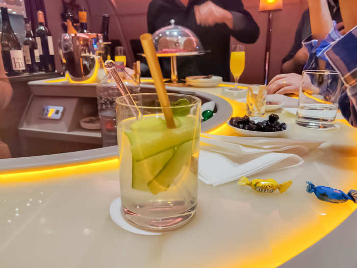 The flight attendants are excellent bartenders. After watching a movie, I went to the cocktail lounge at the back of the plane for a drink. The bartender mixed up an experimental drink at my request, turning a cucumber fizz mocktail into an alcoholic drink.