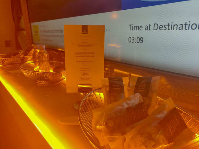 After my meal, I took a nap. A few hours later, I got up to see what was in the lounge area in back. The best part of business class is that it is always stocked up with drinks and snacks like fresh fruits, sandwiches, pastries, chips, and other goodies.