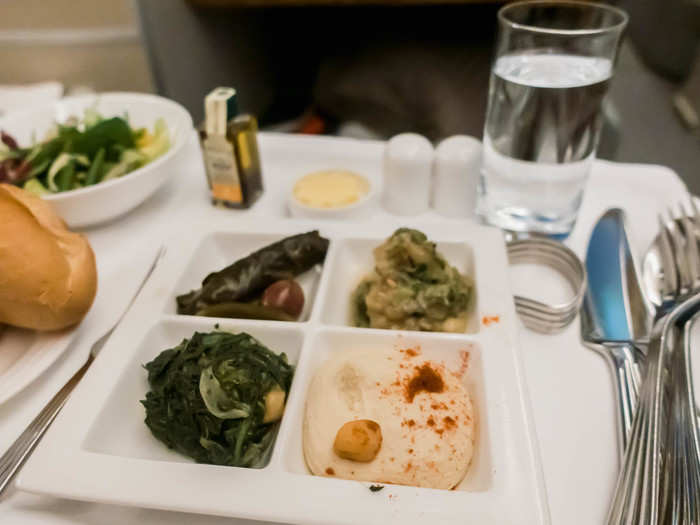 The mezze included four small portions of cold Arabic appetizers, including a roasted eggplant salad, hummus, sautéed spinach with chickpeas, and stuffed grape leaves.