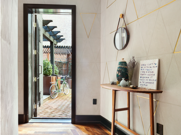 The entry hall leads out to 1,120 square feet of outdoor space.