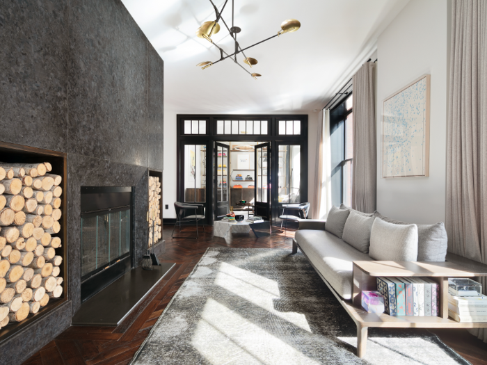 A custom granite wood-burning fireplace acts as the focal point for the room.