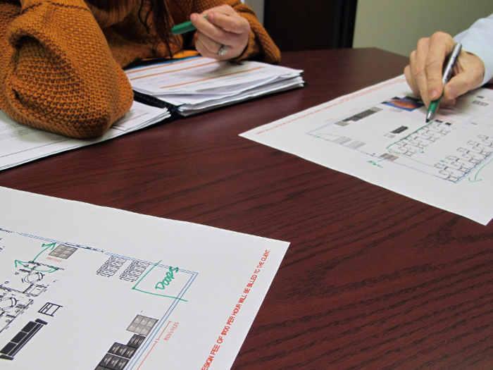 After lunch, Caballero meets with the office supervisor and photography manager, Casey, to review plans for a new office.