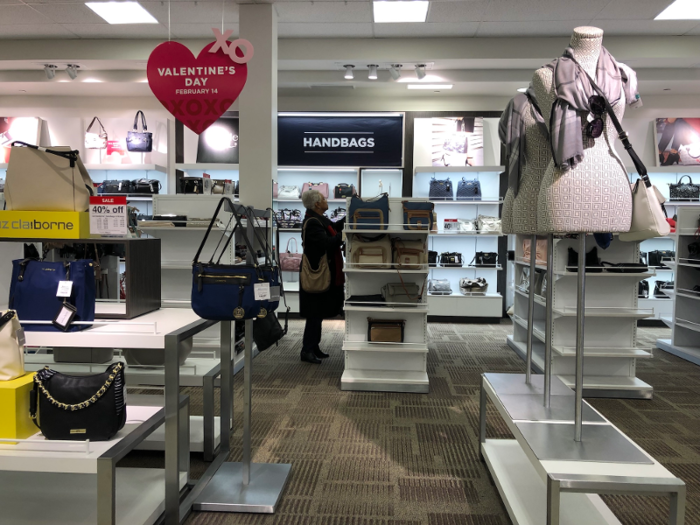 Backlit shelving lined the walls of the handbag department and made this section of the store feel high-end.