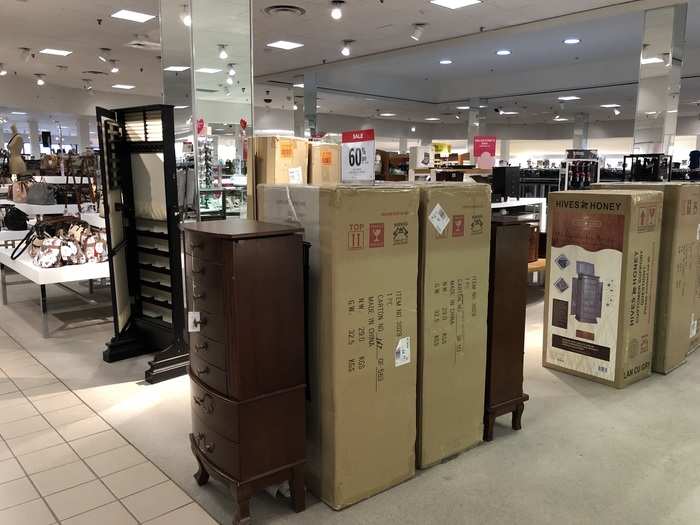 Displaying boxed furniture could be an attempt to fill empty floor space or reduce employees