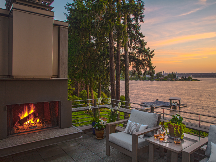 On the rooftop is a deck with a fireplace and native plants.