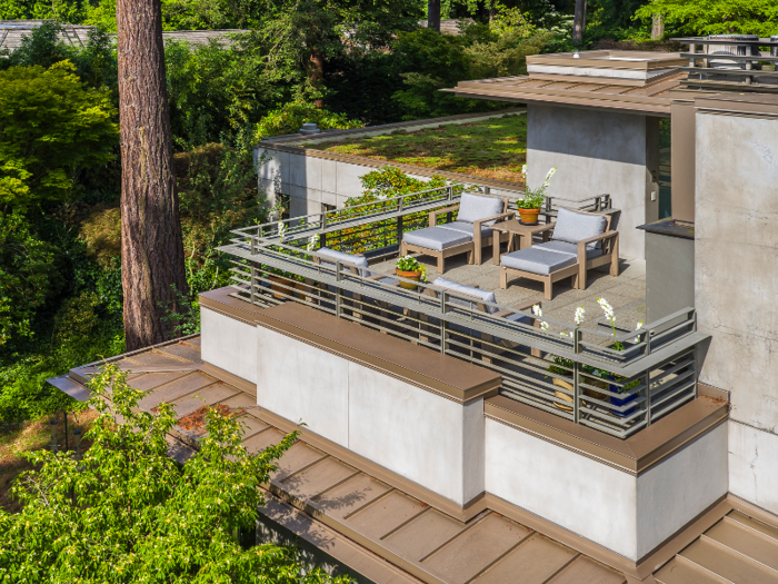 Outside, several outdoor living spaces offer views of the lake.