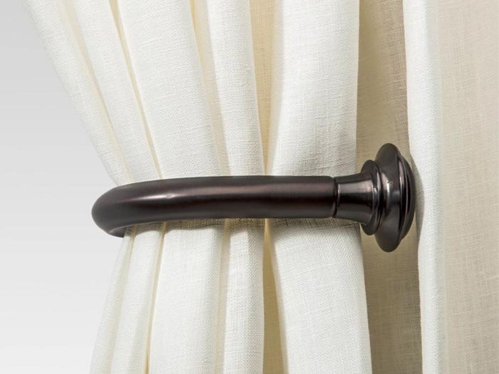 A bronze curtain holdback