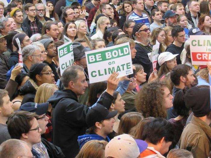 Other attendees carried signs expressing their concern about climate change.