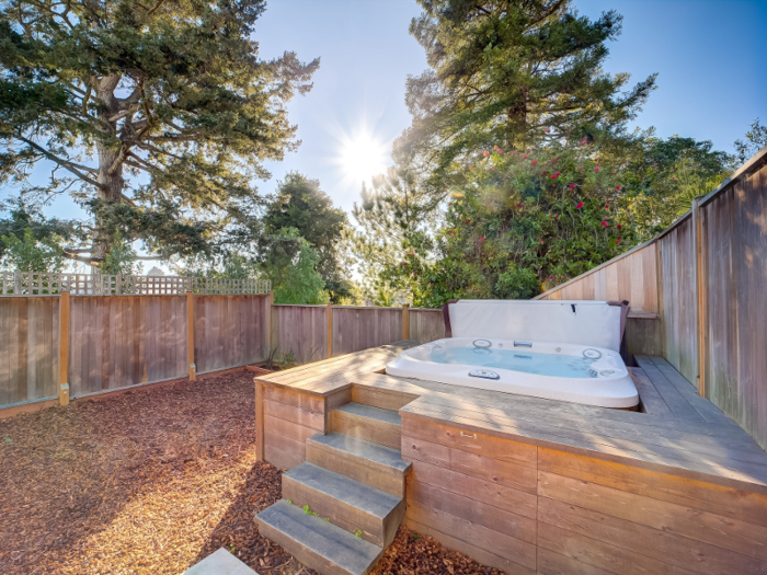 A spa hot tub sits feet from the balcony doors.