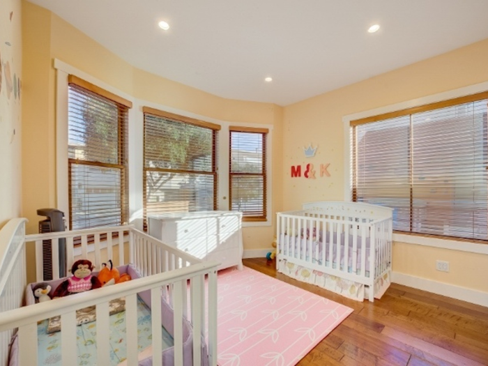 Below the loft is a bedroom that faces the street.