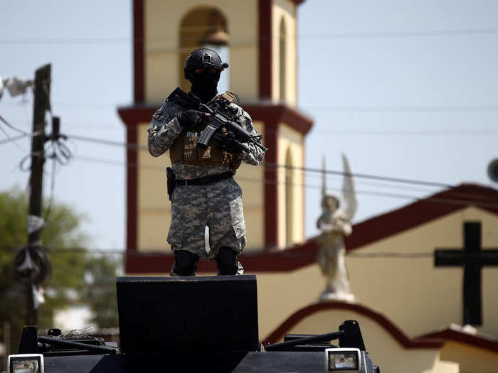 Authorities said residents in the town of 2,800 were paid to stop the troops and police and to report their movements to the cartel. Police said they found envelopes with the cartel