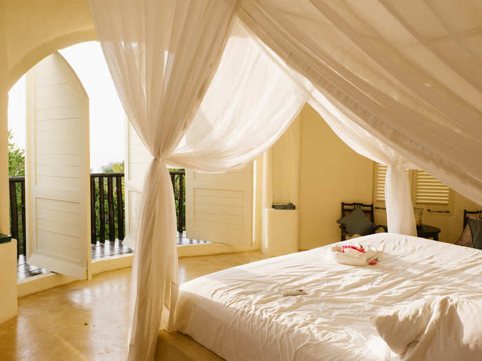 Each pavilion has three levels. The first is the bedroom pavilion, which includes a four-poster king-size bed surrounded by a mosquito net. At one end of the bedroom are three wooden doors that open onto a balcony overlooking the ocean.