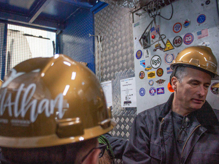 We all squeezed into the construction elevator in our golden hard hats ...