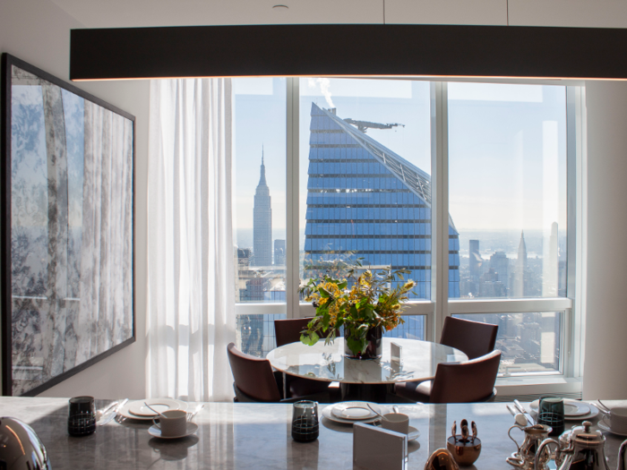 The kitchen offers views of the Empire State Building and the East River in the distance.