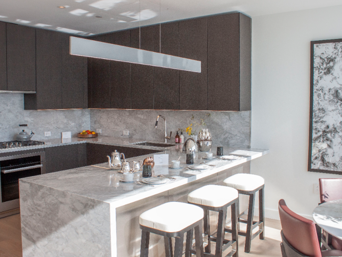 The kitchen is outfitted with custom oak wood cabinetry and Miele appliances.