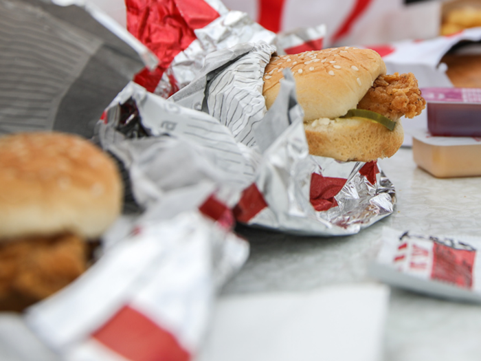 The mini-sandwiches, dressed with pickles, are one of KFC