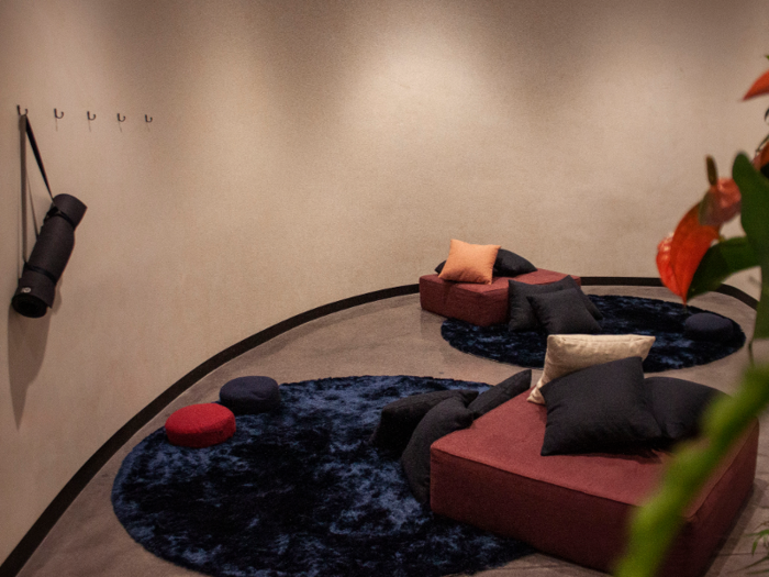 The yoga, meditation, and nap room is currently furnished with cozy rugs, poufs, and pillows. This is where two Casper nap pods will be placed when they arrive in April. Floor pillows are provided for meditation.