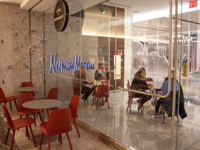 A café sitting area extends into the corridor of the main shopping center.