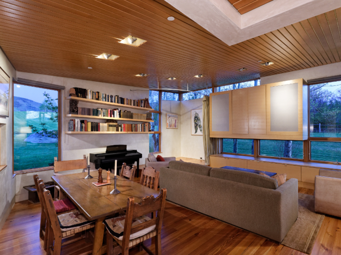 The kitchen leads into the dining area, which has additional couch seating.